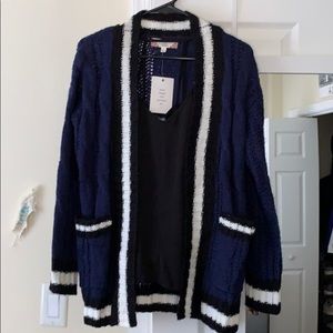 navy blue cardigan with black and white trim